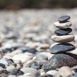 five elements of vastu The pebbles are stacked in a pile at the edge of the river.